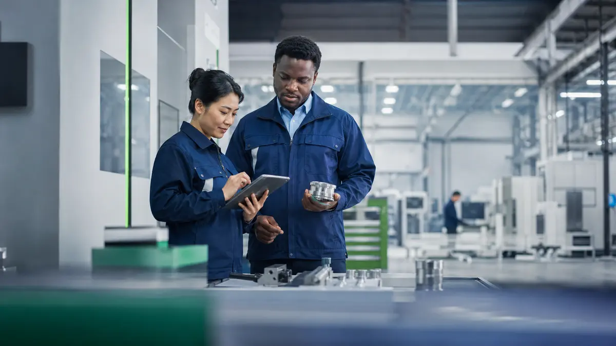 Quality professionals reviewing production controls in a modern manufacturing facility